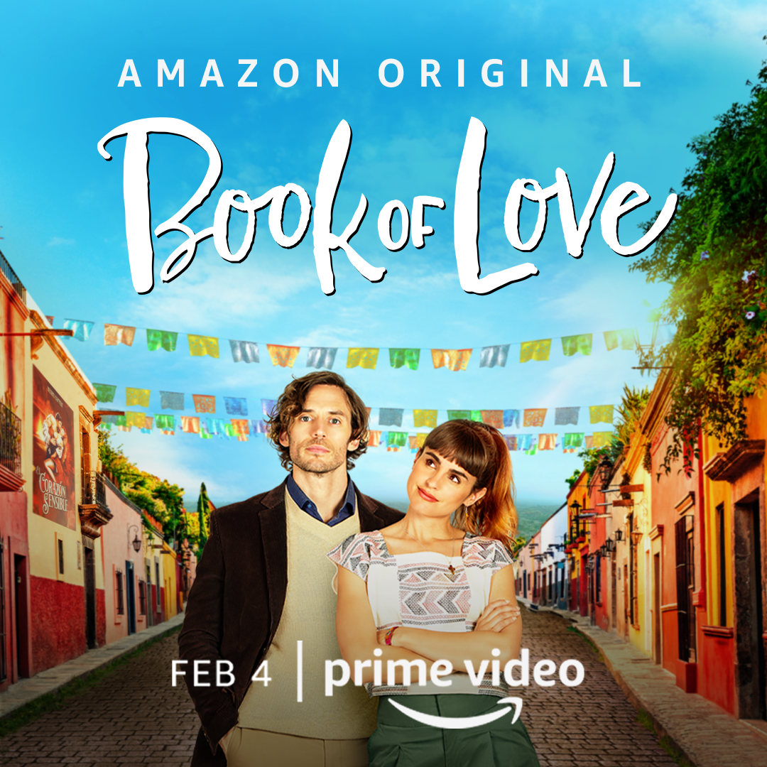 Book of Love promo with couple standing on a street of a cute town