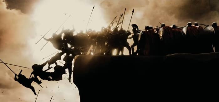 The Spartans driving their enemies off a cliff with the sun shining in the background in &quot;300&quot;