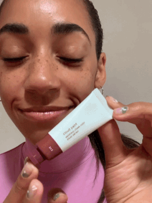 a gif of a model applying cloud paint to their cheeks