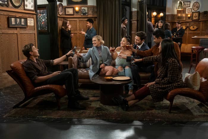 The cast giving a toast during a scene from How I Met Your Father