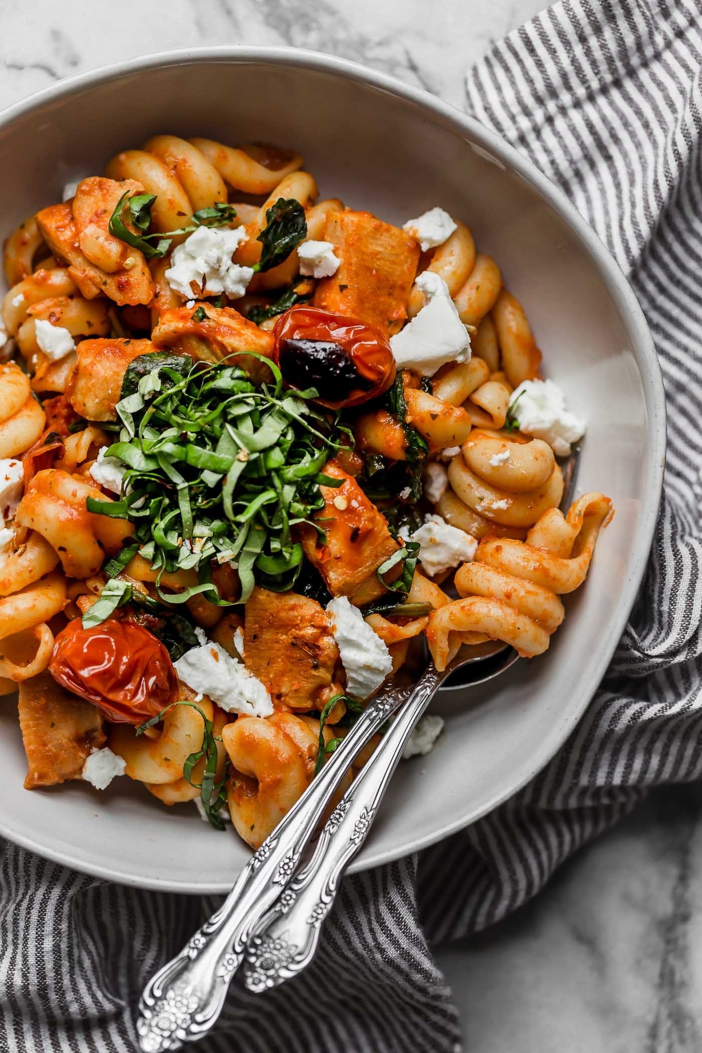 Pasta with chicken, blistered tomato, cheese, and torn basil