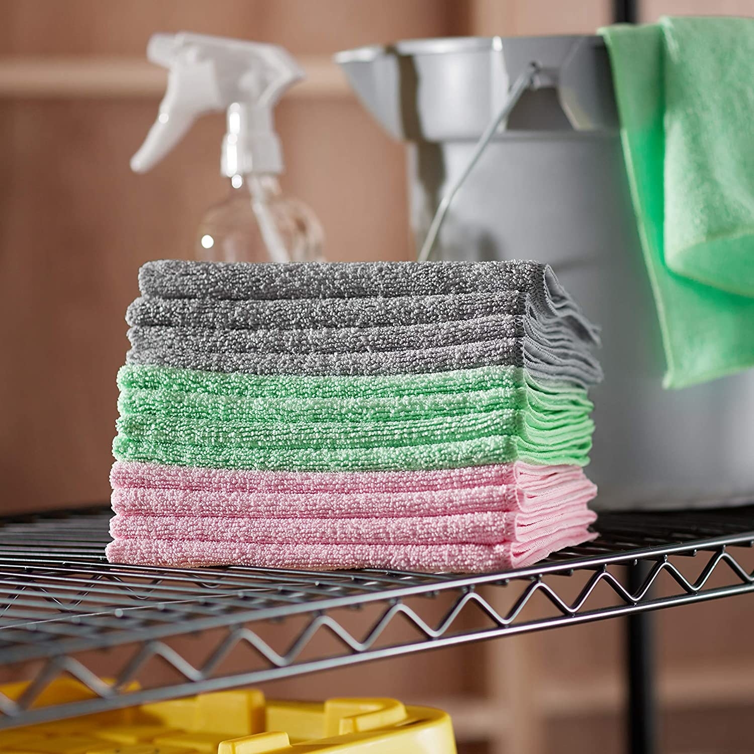 a stack of gray, green, and pink microfiber cloths