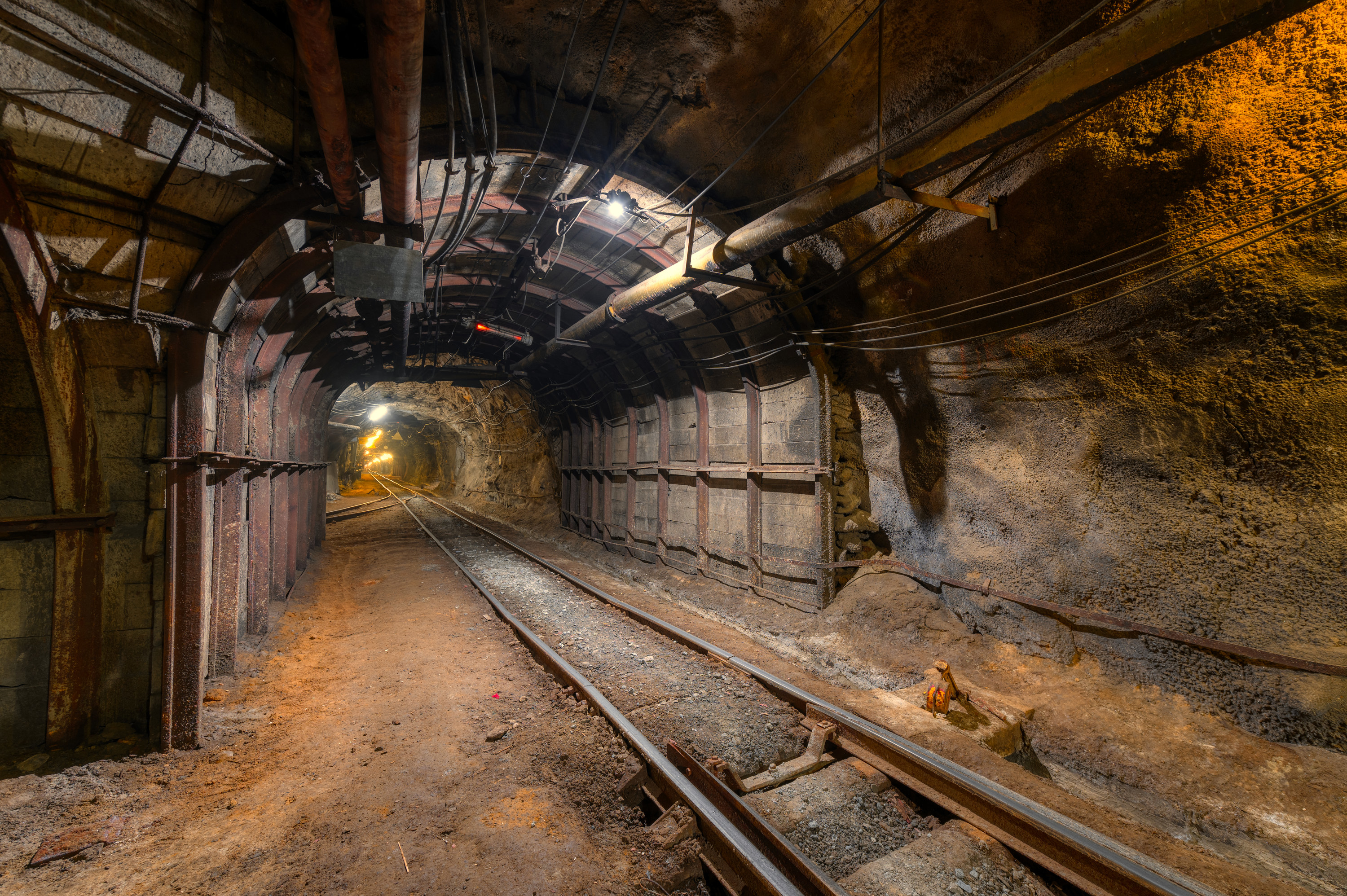 An underground tunnel showing railroad tracks