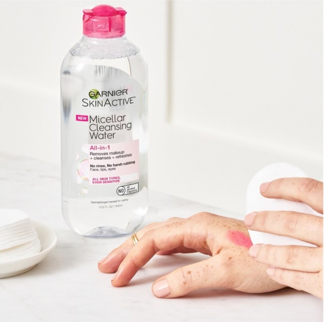 A model removing makeup using micellar cleansing water