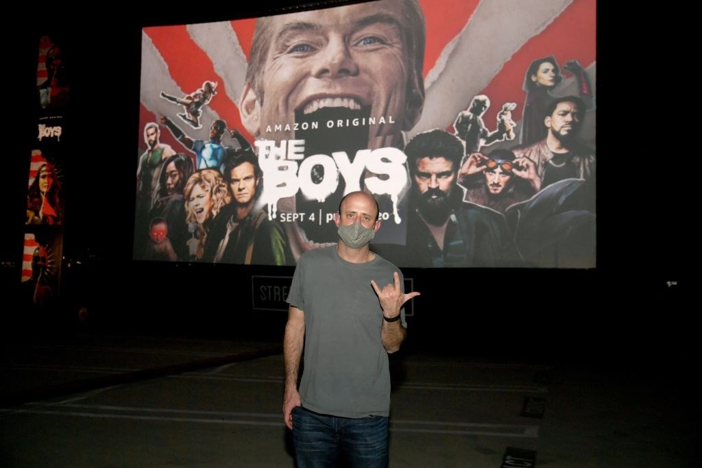 Eric Kripke in front of a giant screen showing the boys&#x27; logo