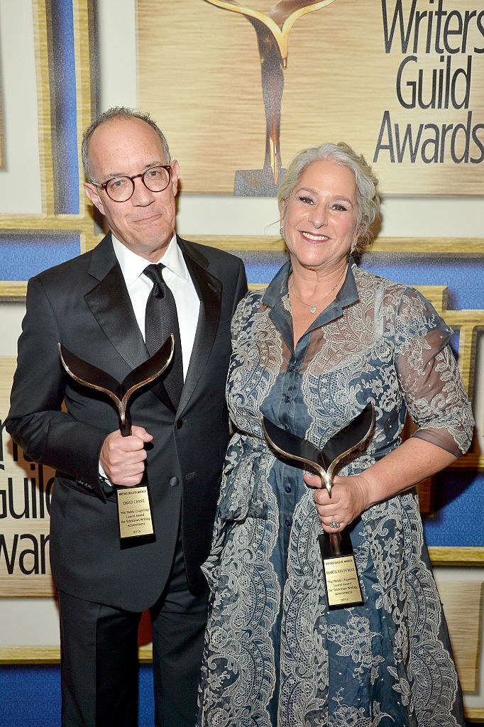 The two showrunners pose with awards