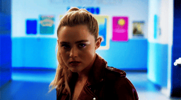 Girl stands in school hallway