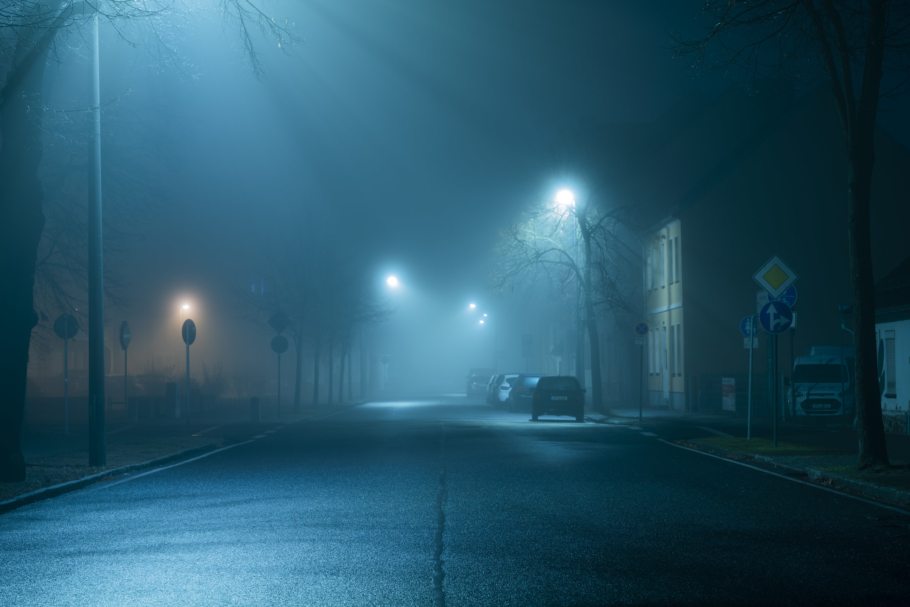 A dark, spooky empty street at night