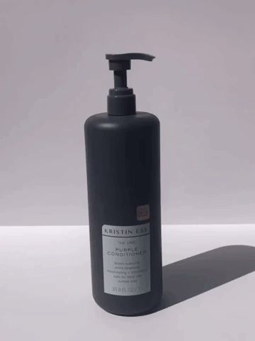 Model pumping purple conditioner into their hand