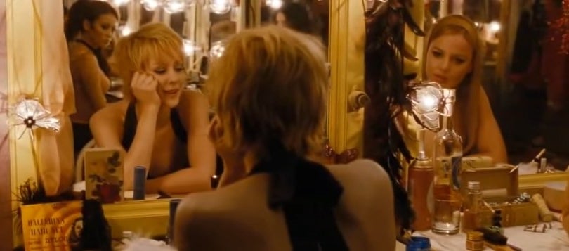 Sweet Pea and Rocket talking to each other in front of makeup mirrors in &quot;Sucker Punch&quot;