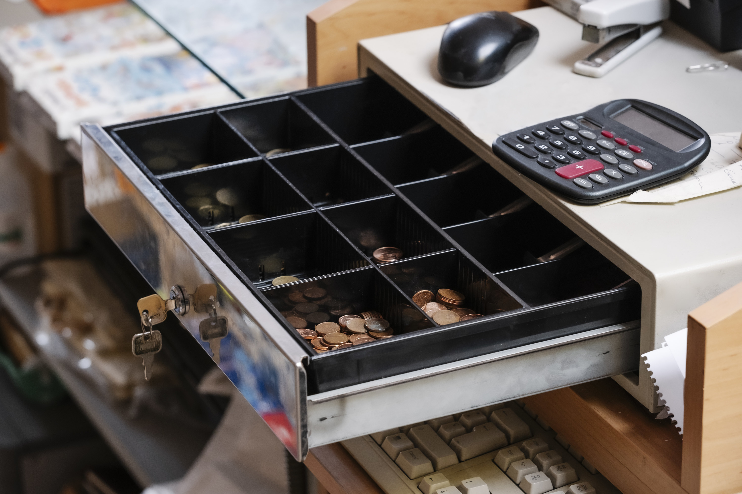 A cash register&#x27;s drawer open showing its money