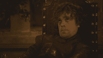Tyrion cheersing with a glass of wine