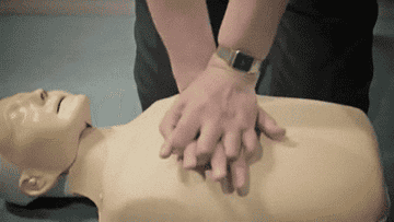 Person demonstrating CPR on a dummy