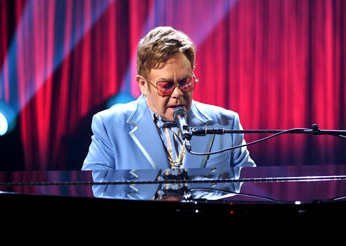 Elton performs at the piano