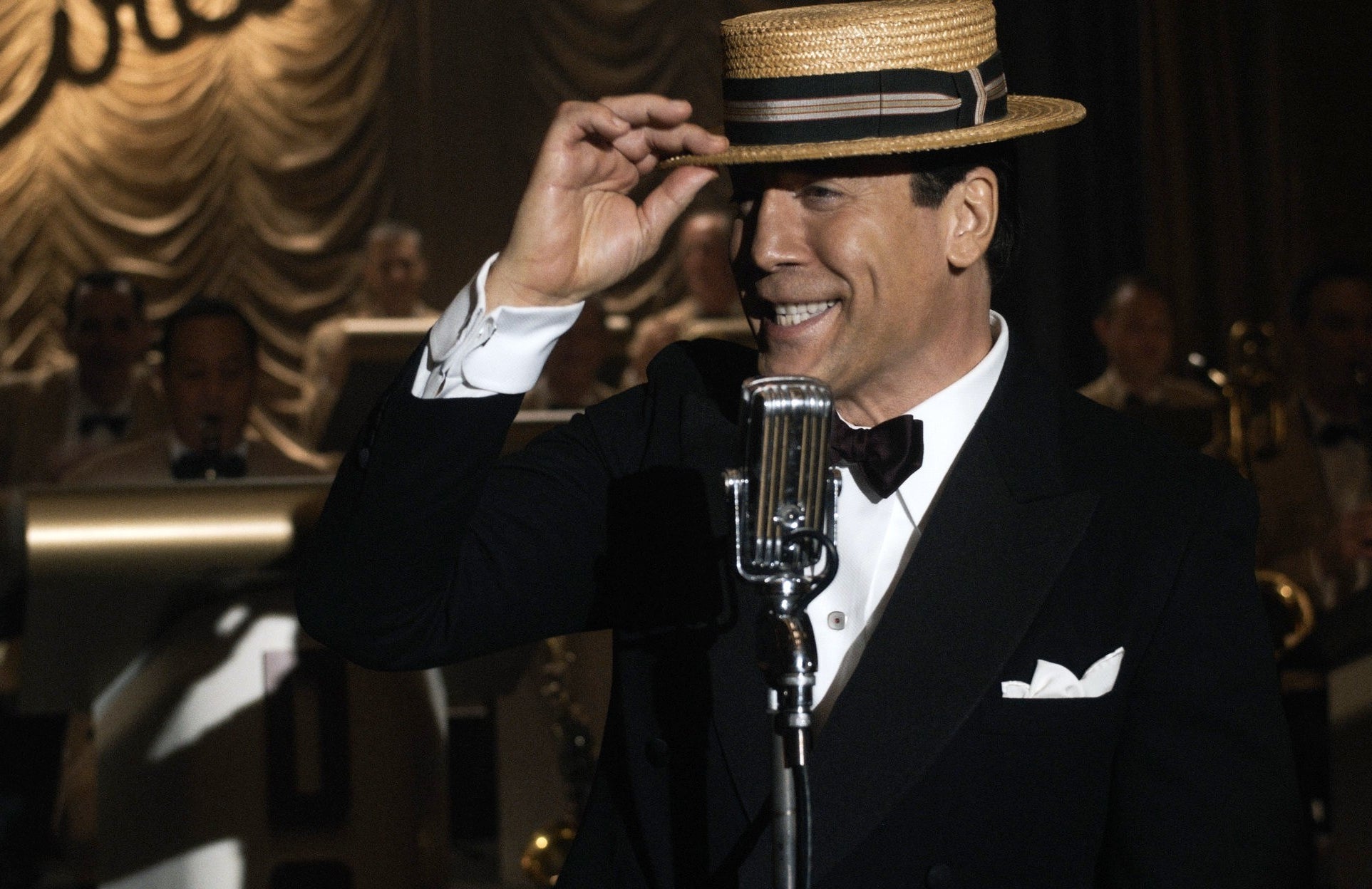 Javier in character as Desi Arnaz in front of a microphone