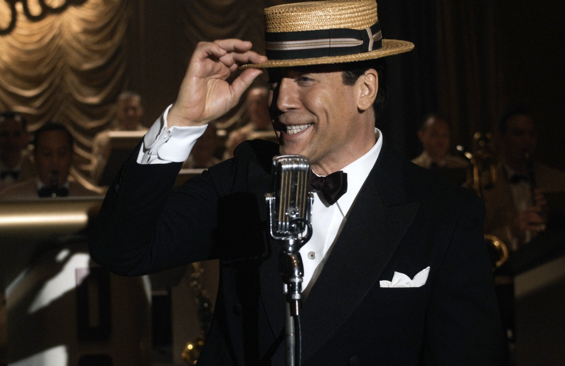 Javier in character as Desi Arnaz in front of a microphone