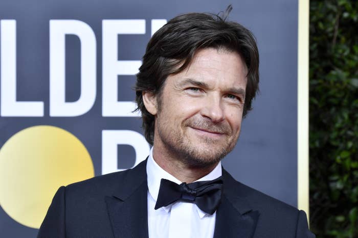 Bateman smiles at a red carpet event