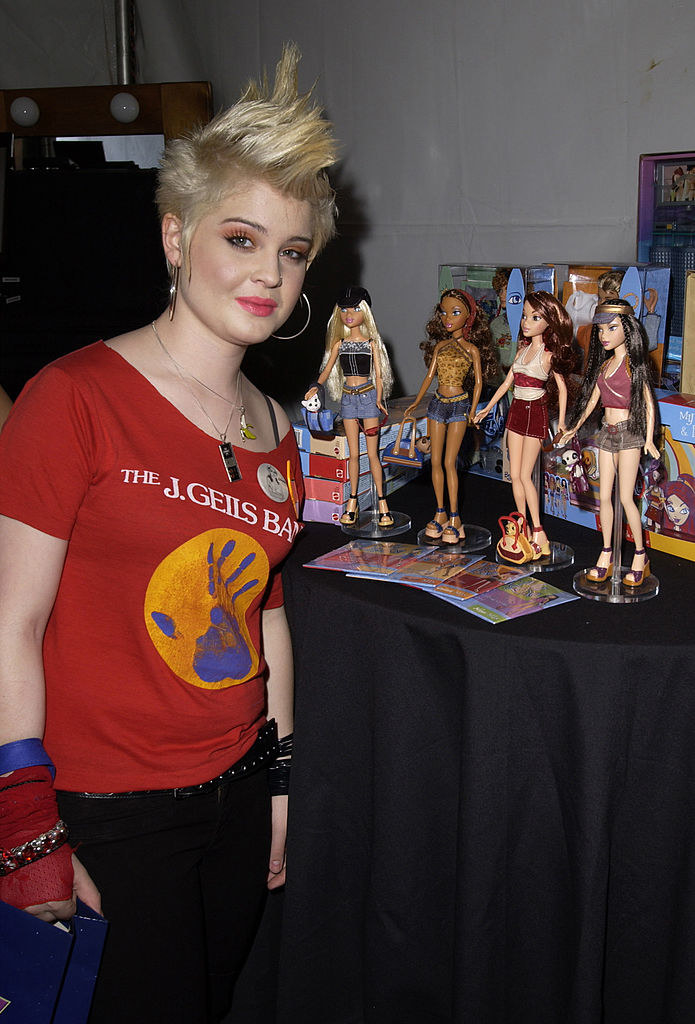 kelly next to some dolls
