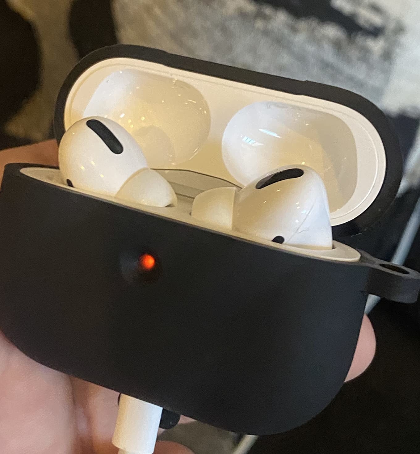 The Airpods in a holder