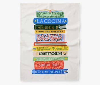 a tea towel with a stack of illustrated cook books on it