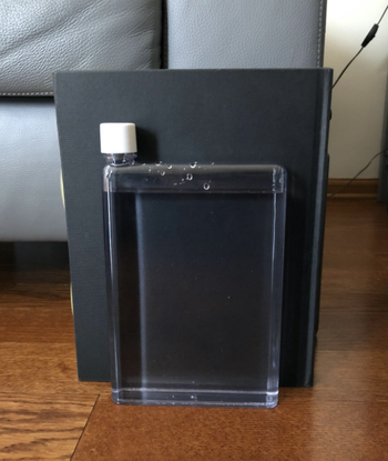 review image of the water bottle flat against a book