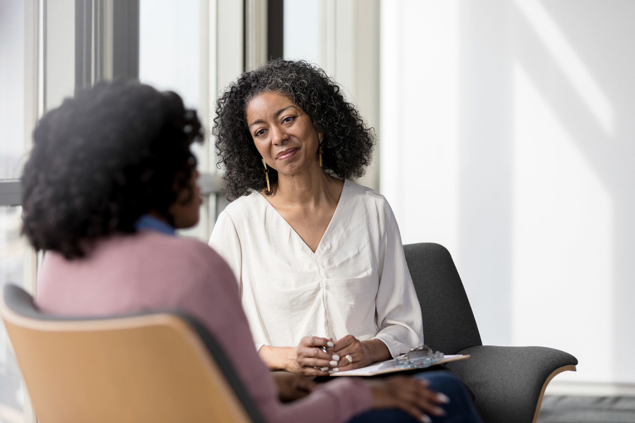 A therapist listens compassionately to a client while she shares her problems.