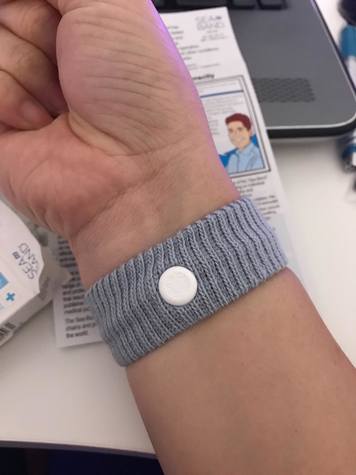 a reviewer wearing the nausea wristband