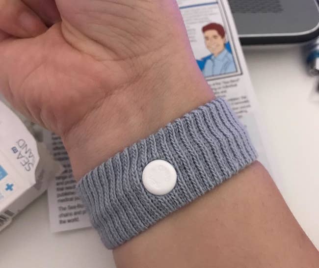a reviewer wearing the nausea wristband