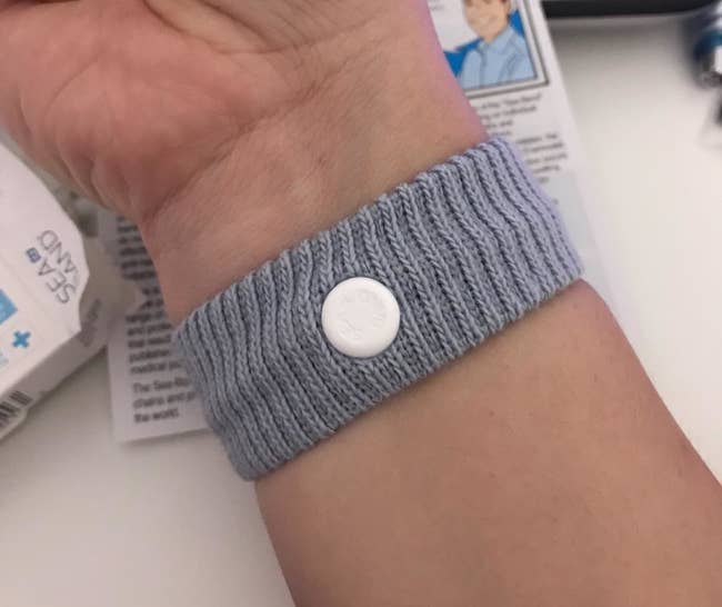 a reviewer wearing the nausea wristband