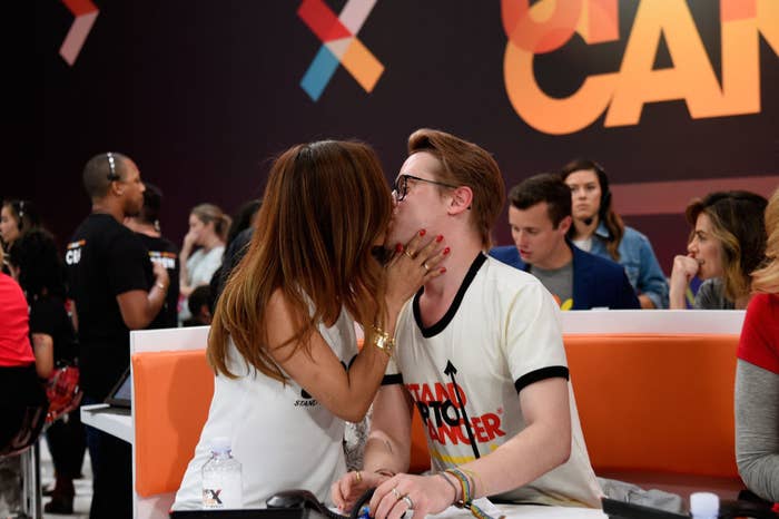 The couple kissing during a phoneathon for Stand Up to Cancer