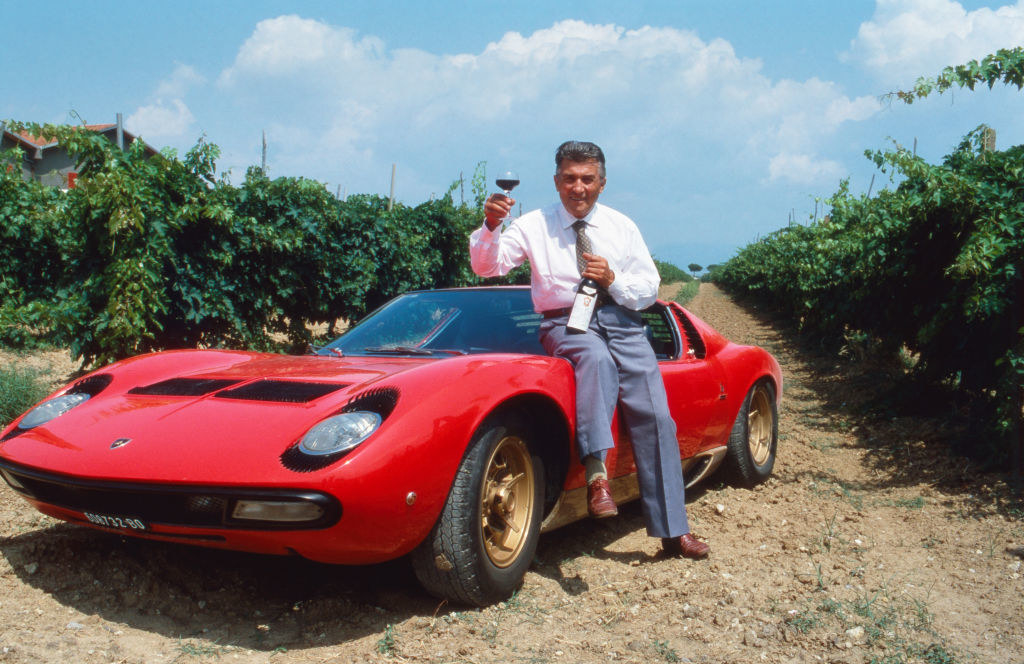 Ferruccio Lamborghini standing next to his car