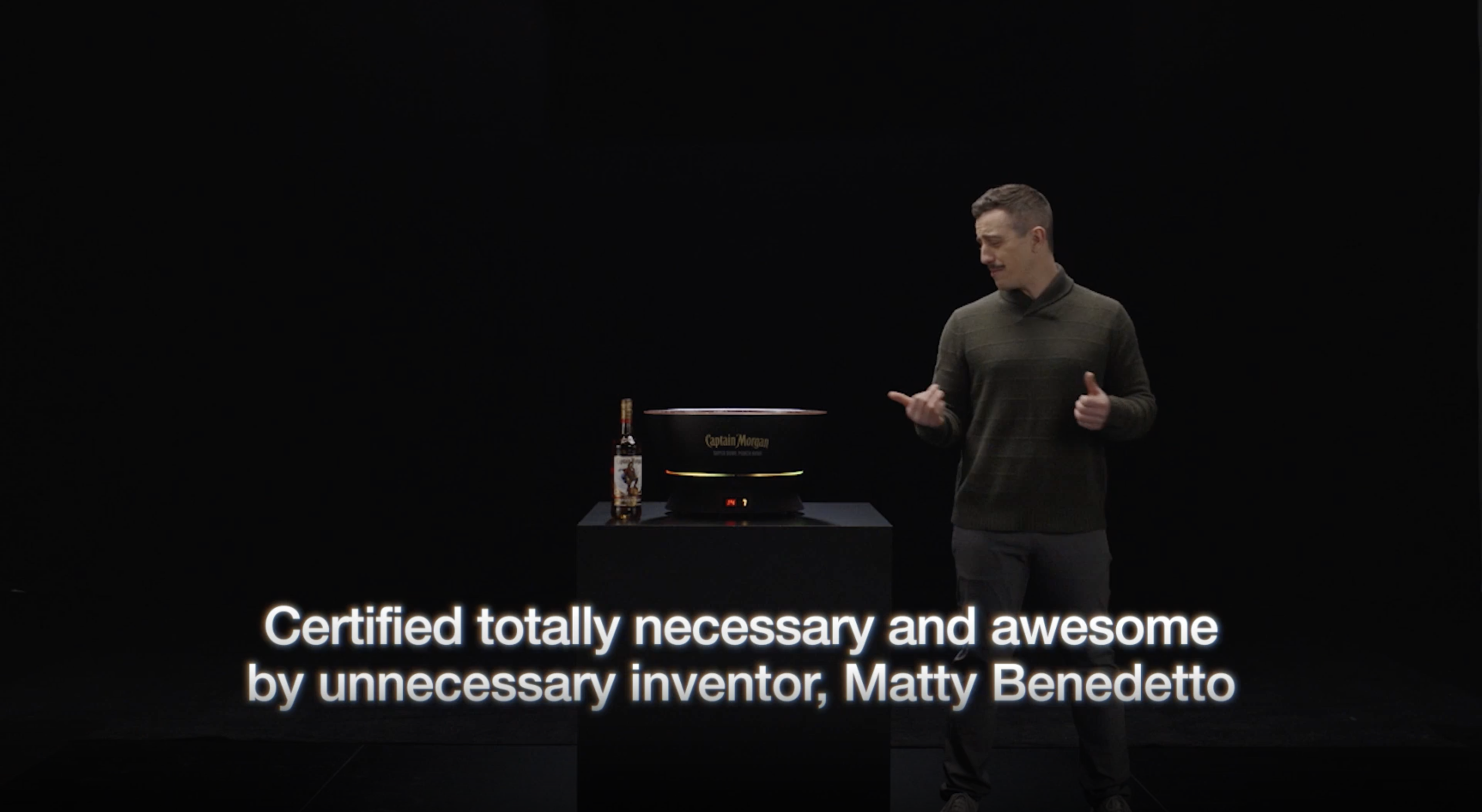 Matty Benedetto standing next to the Super Bowl Punch Bowl with text that reads, &quot;Certified totally necessary and awesome by unnecessary inventor, Matty Benedetto&quot;
