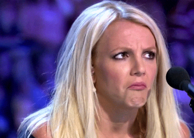 Britney Spears judging X-factor and giving a surprised frown look