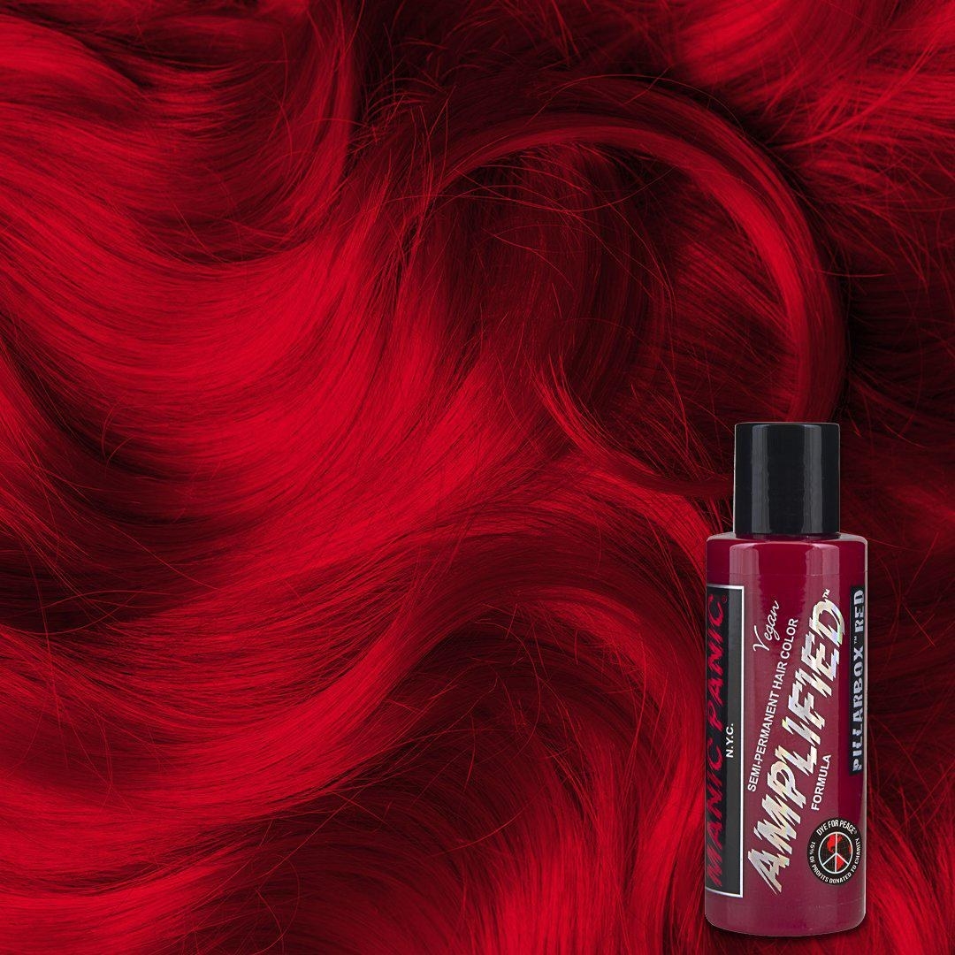 Bottle of burgundy hair toner that reads &quot;Manic Panic amplified&quot; on top of bright red hair