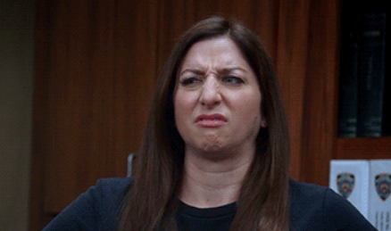 Gina from Brooklyn Nine Nine scrunching her face and giving a dirty look