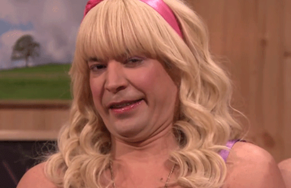 Jimmy Fallon wearing a headband and wig, with a grossed-out expression