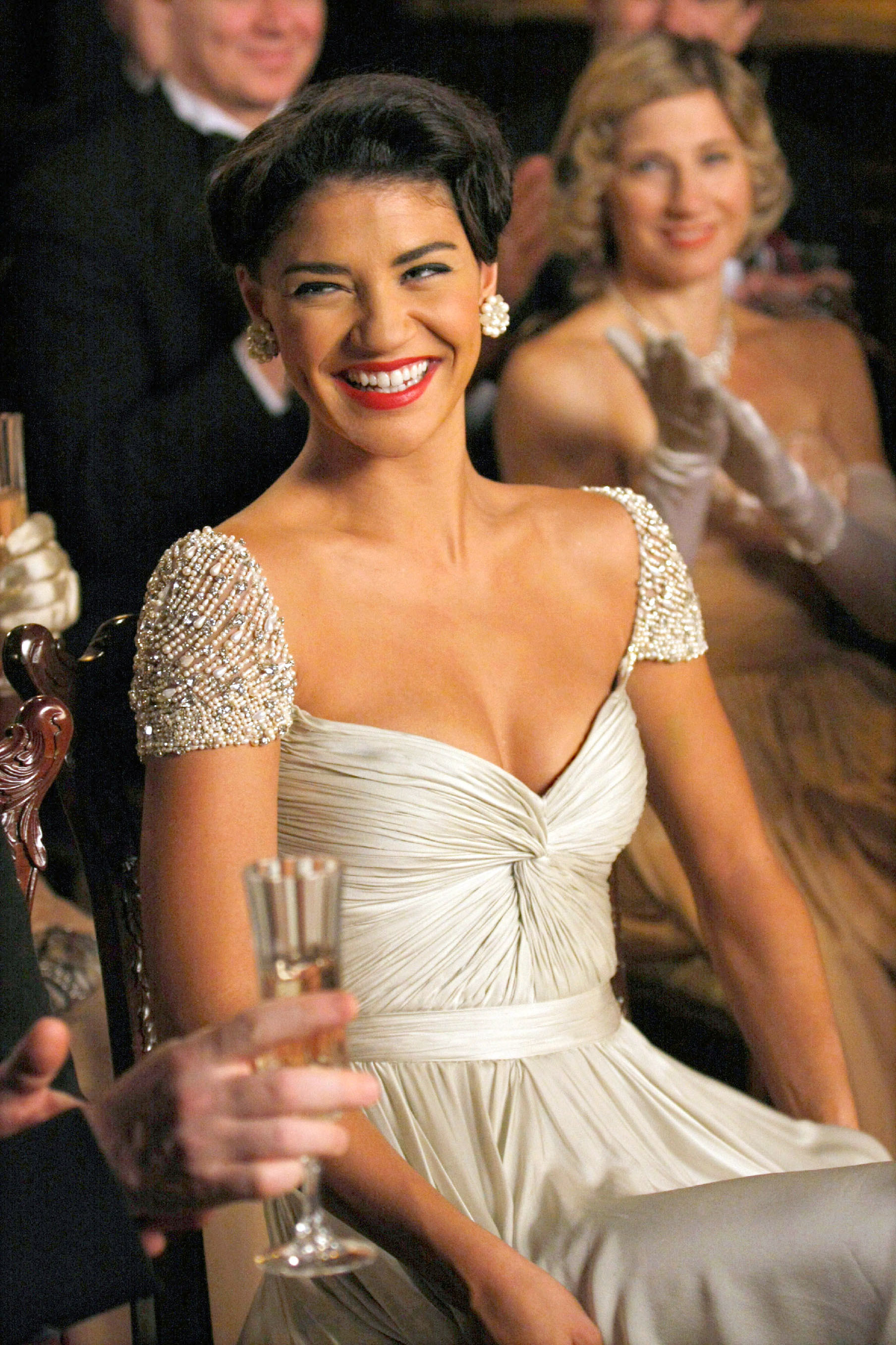 Vanessa smiling at a formal event while wearing a beaded and satin dress