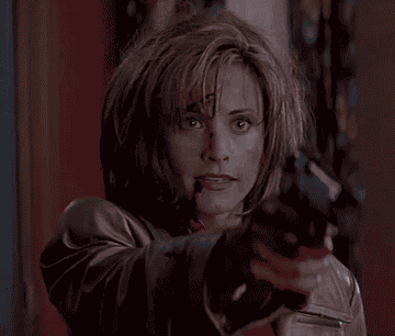 Gale Weathers holding up a gun in Scream