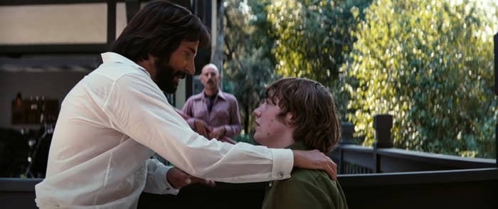 Cooper puts his hand on Cooper Hoffman&#x27;s shoulders in a scene from the film