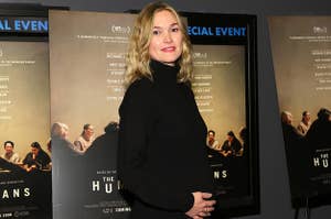 Julia holds her baby bump at an event