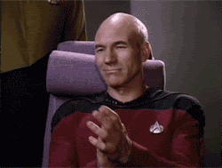 Captain Picard from Stark Trek slow claps while wearing his iconic red suit