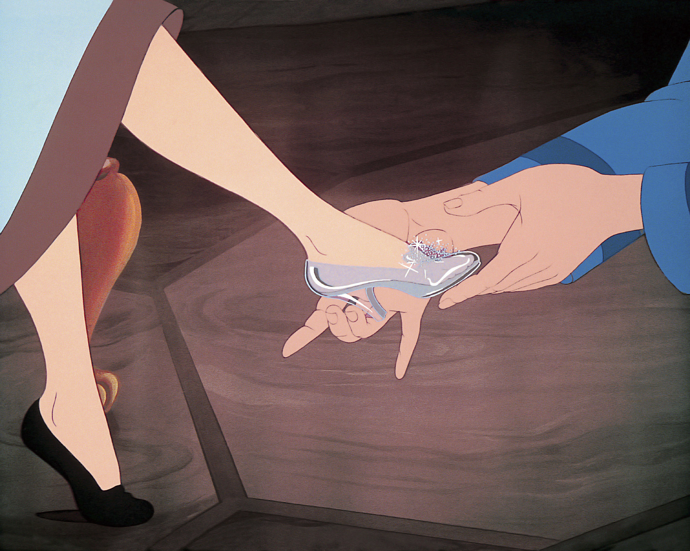 Cinderella getting the glass slipper put on her foot