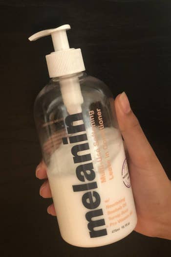 the same writer holding the conditioner bottle