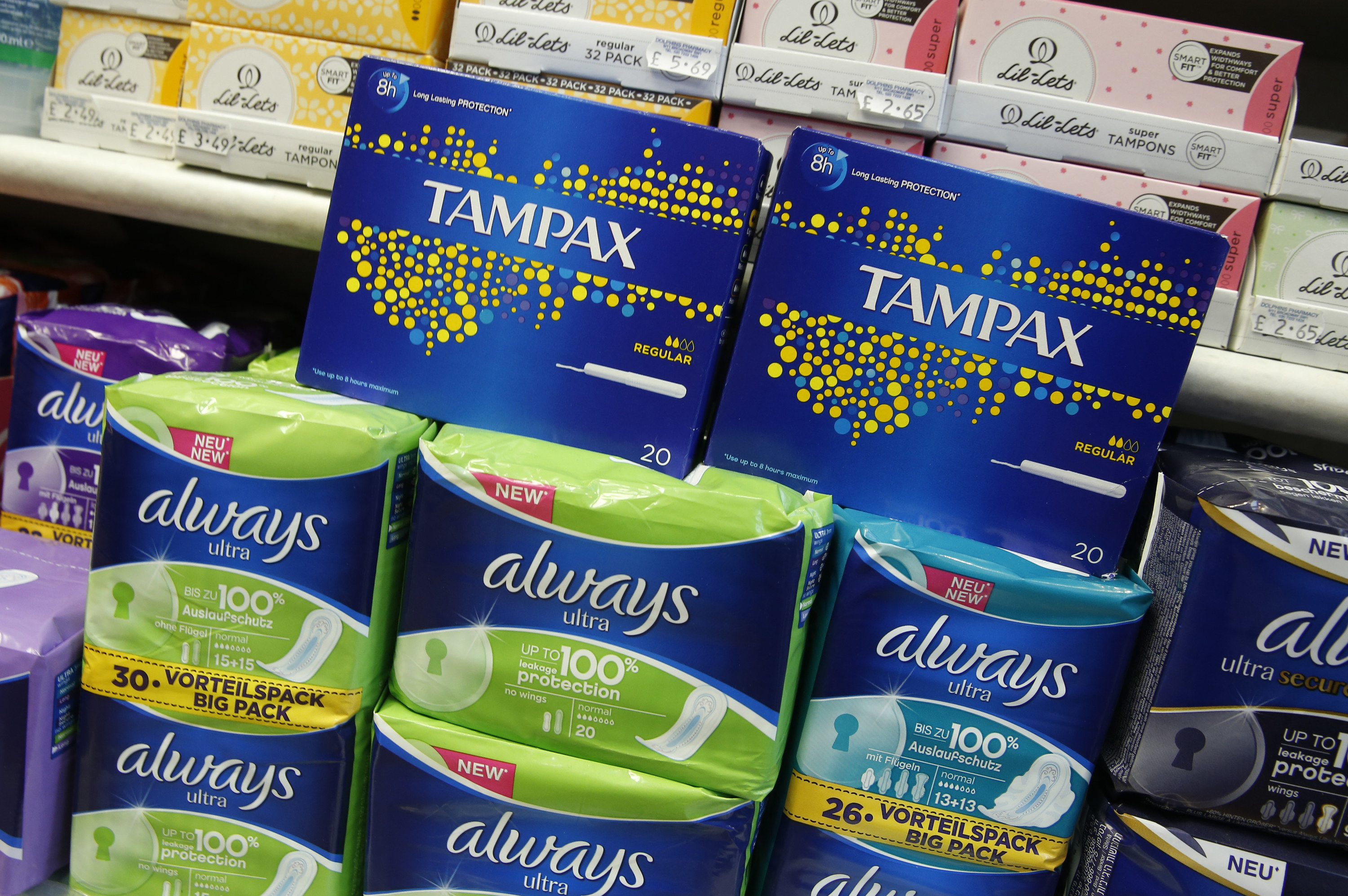 Tampons and pads on shelves in a pharmacy