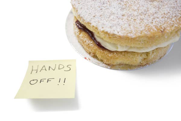 Sponge cake with 'hands off' sign on a post-it note
