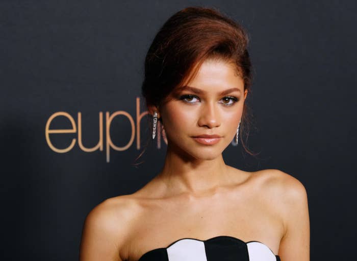 Zendaya wearing a striped, strapless column dress on the red carpet
