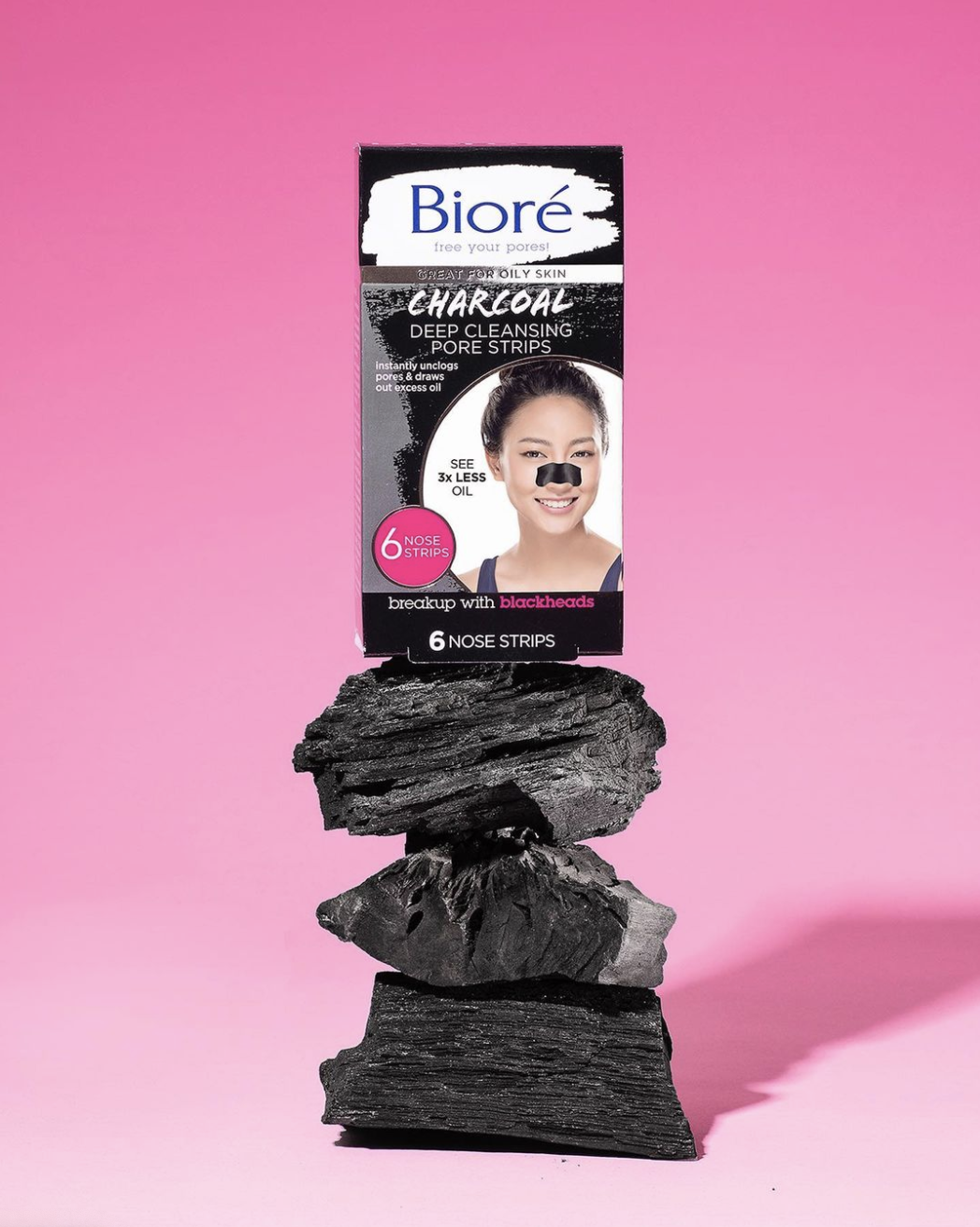 A pack of deep cleansing charcoal pore strips on a stack of charcoal