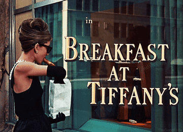 Holly golightly in breakfast at tiffany&#x27;s pulling a coffee out of a bag
