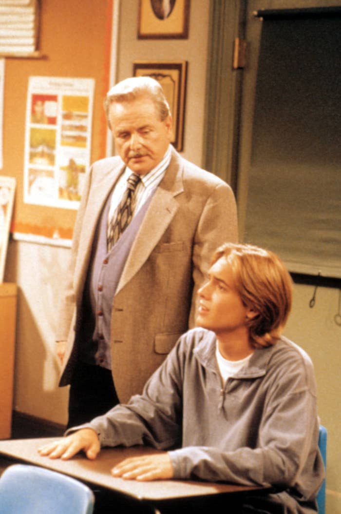 Mr. Feeny looking at Eric as Eric sits in a desk in a scene from Boy Meets World
