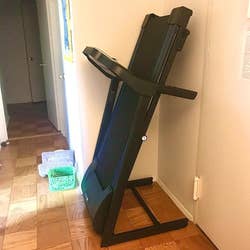 the treadmill folded up against a wall